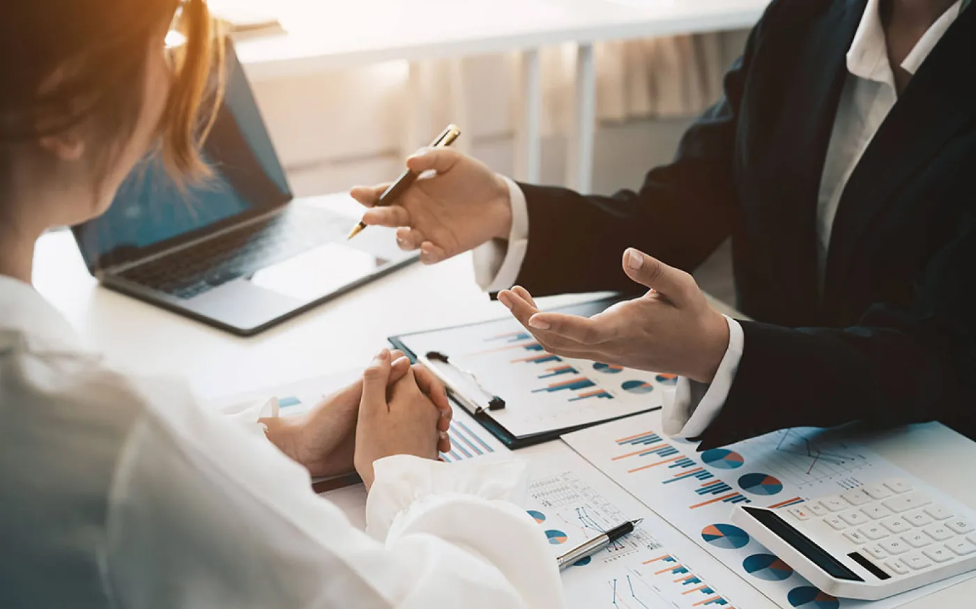 Advisor discussing plan of investment of financial report to clients