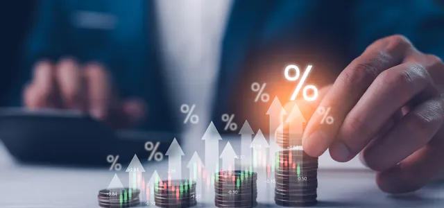 Dividend and interest rates with symbols and arrows up on stacks of coins